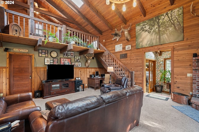 carpeted living room featuring wood walls, wood ceiling, beam ceiling, and high vaulted ceiling