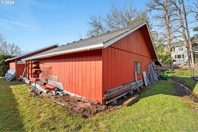 view of property exterior featuring an outdoor structure and a lawn