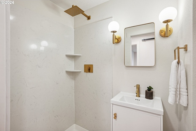 bathroom featuring walk in shower and vanity