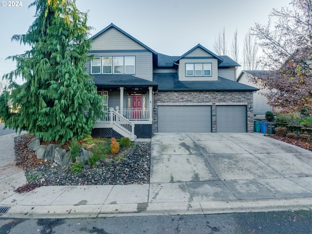 craftsman inspired home featuring a porch and a garage