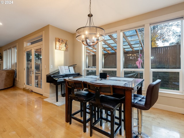 dining area featuring a chandelier and light wood-type flooring