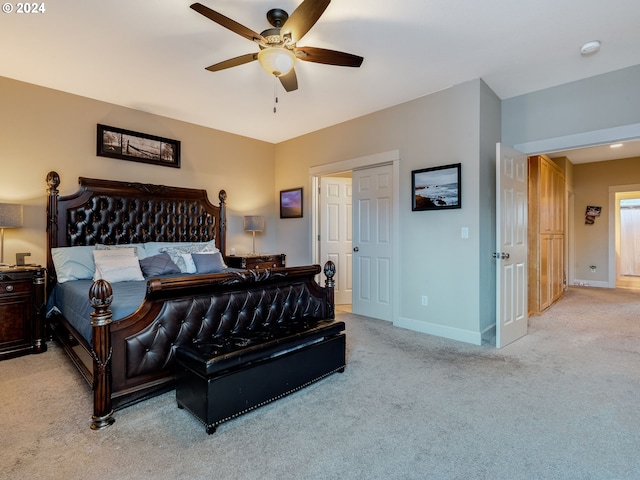 bedroom with ceiling fan and light colored carpet