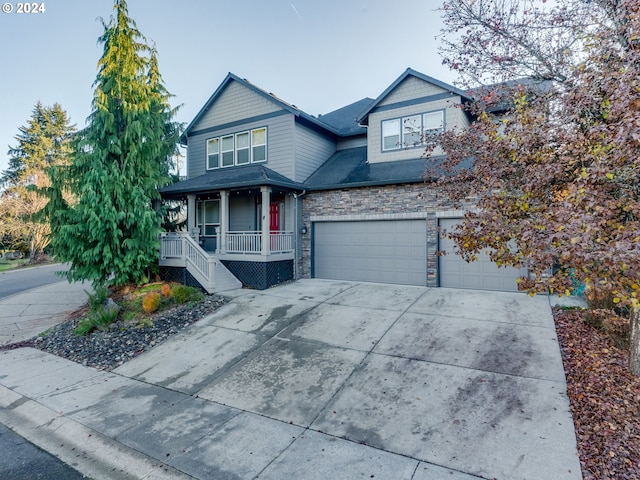 view of front of property featuring a porch and a garage