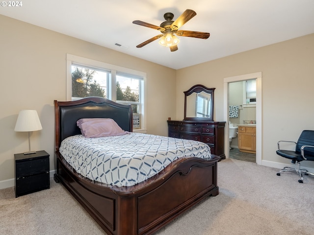 carpeted bedroom with ceiling fan and ensuite bathroom