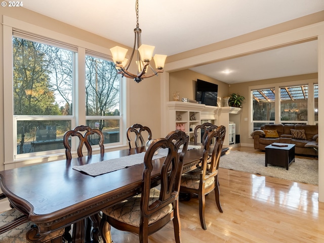 dining space featuring a notable chandelier and light hardwood / wood-style floors