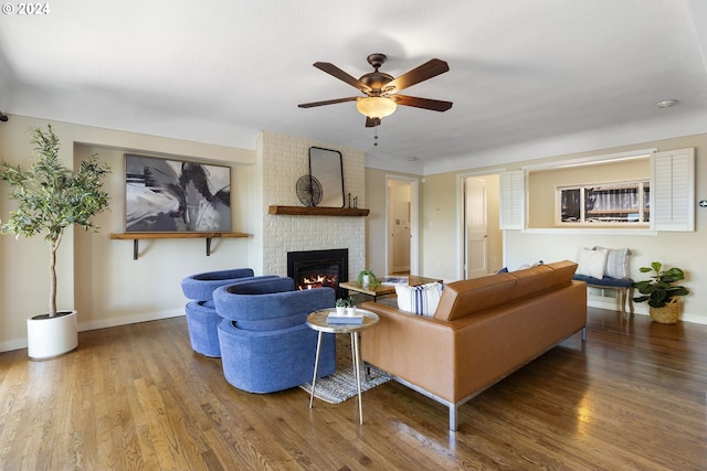 living room with ceiling fan, a fireplace, and hardwood / wood-style flooring