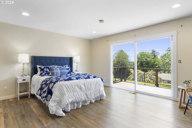 bedroom with access to outside and wood-type flooring