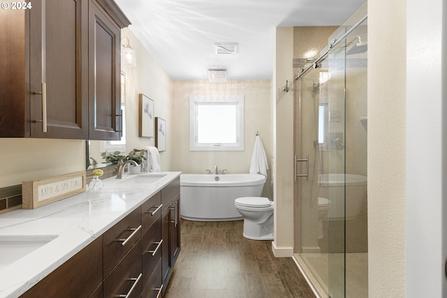 bathroom featuring hardwood / wood-style floors, vanity, and shower with separate bathtub