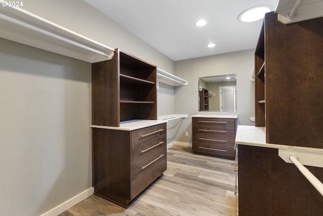 spacious closet with light hardwood / wood-style flooring