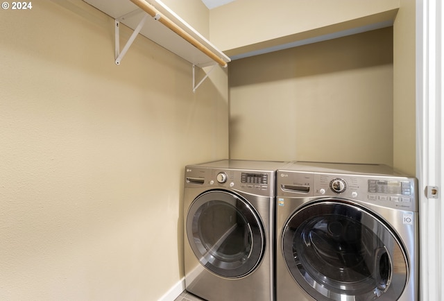 clothes washing area with washer and clothes dryer