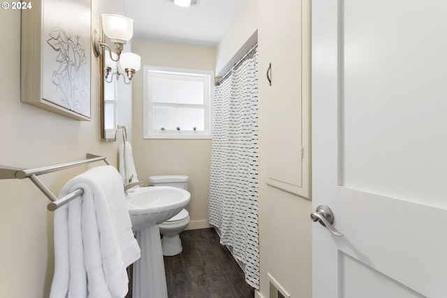 bathroom featuring hardwood / wood-style floors, toilet, and a shower with shower curtain