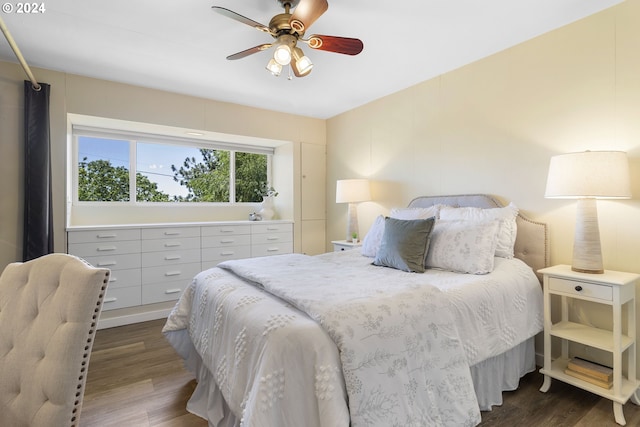 bedroom with ceiling fan and dark hardwood / wood-style floors