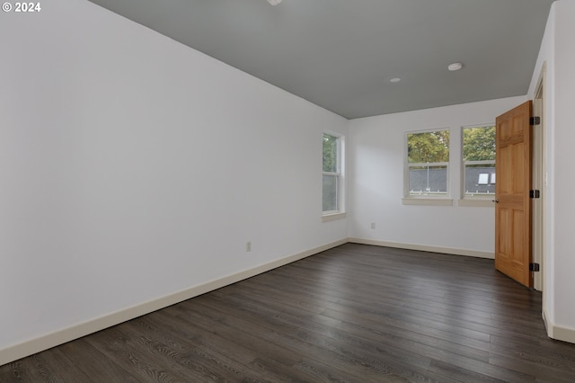 unfurnished room featuring dark wood-type flooring