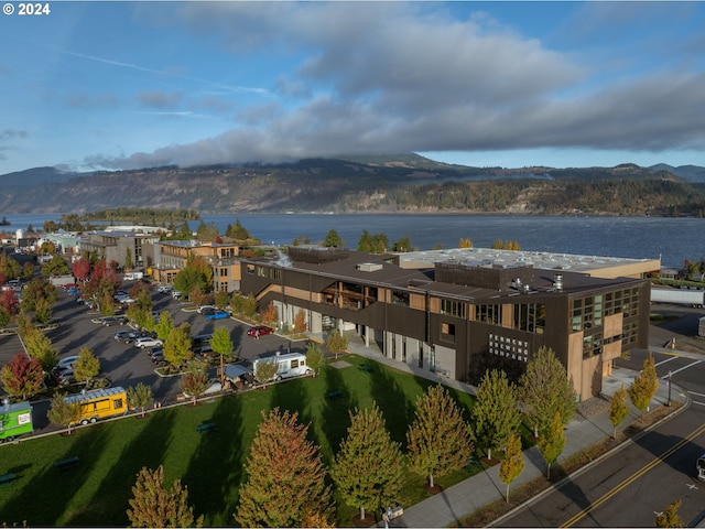 drone / aerial view featuring a water and mountain view