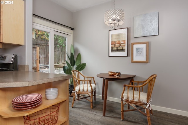 sitting room with hardwood / wood-style floors and an inviting chandelier