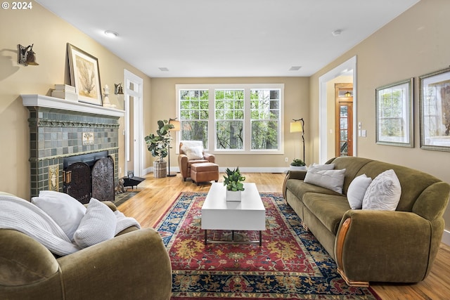 living room with light hardwood / wood-style floors and a fireplace