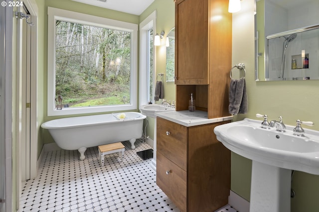 bathroom featuring tile floors, a bathtub, and sink