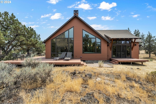 back of property featuring a wooden deck