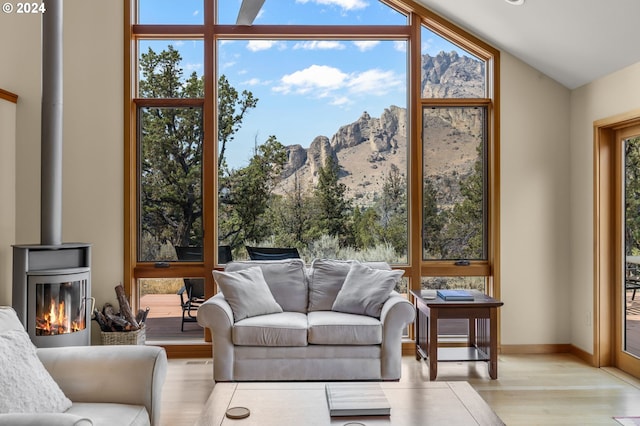 living room with floor to ceiling windows, a mountain view, and wood finished floors