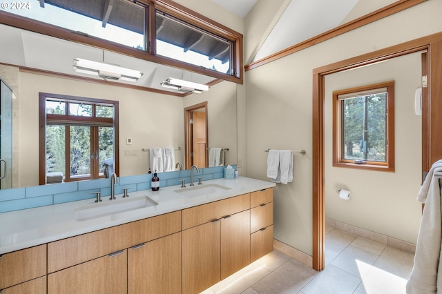 bathroom featuring tile patterned flooring, vanity, and a healthy amount of sunlight