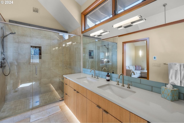 bathroom featuring vanity, tile patterned floors, walk in shower, and vaulted ceiling