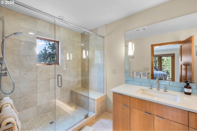 bathroom with tile patterned flooring, vanity, and a shower with door