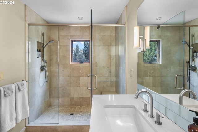 bathroom featuring vanity, an enclosed shower, and a healthy amount of sunlight