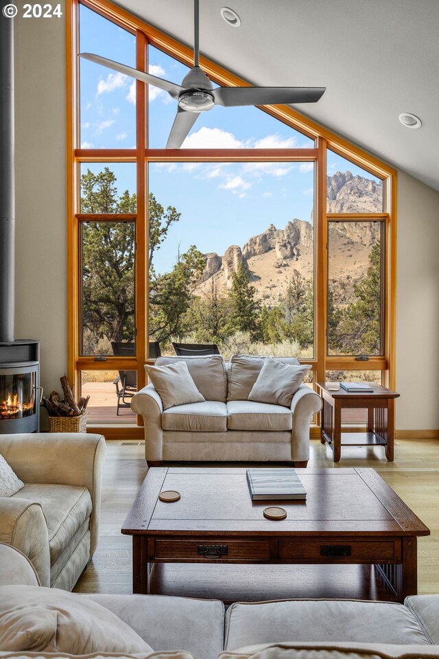wooden deck with a mountain view and outdoor dining space