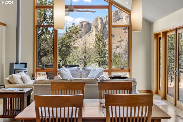 sunroom with a mountain view and a wood stove