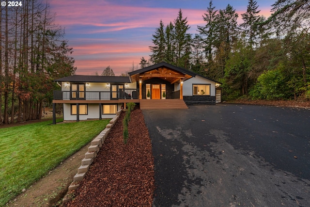 view of front of house featuring a lawn and a deck