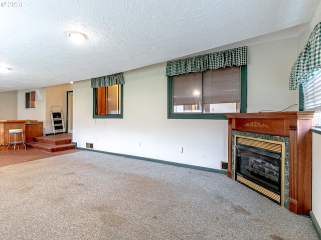 living room featuring a dry bar, a premium fireplace, baseboards, and carpet flooring