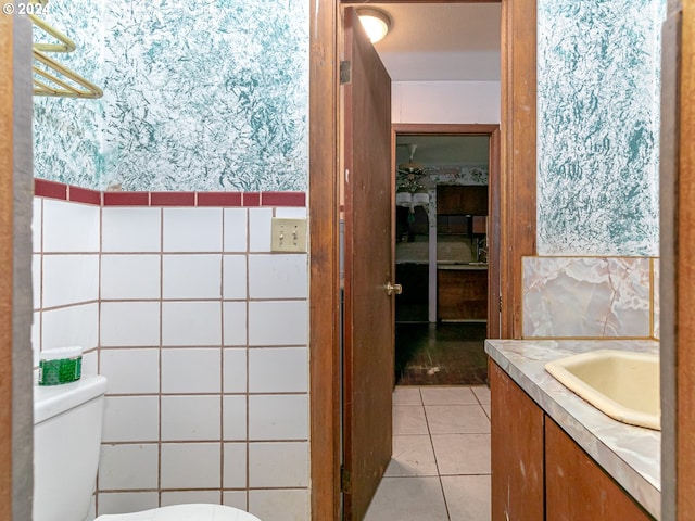 bathroom with tile patterned flooring, vanity, and toilet