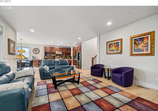 living room featuring built in desk and light hardwood / wood-style flooring