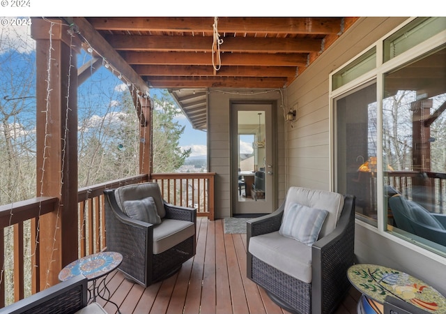 wooden deck with area for grilling and outdoor lounge area