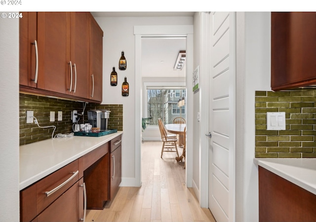 kitchen featuring decorative backsplash and light hardwood / wood-style floors