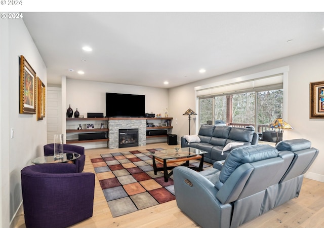 living room with a fireplace and light hardwood / wood-style flooring