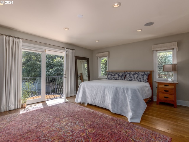 bedroom featuring light wood-type flooring and access to exterior