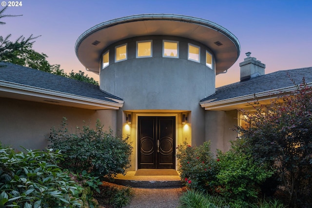 view of exterior entry at dusk