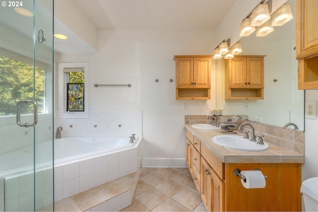 bathroom with shower with separate bathtub, tile patterned flooring, and vanity