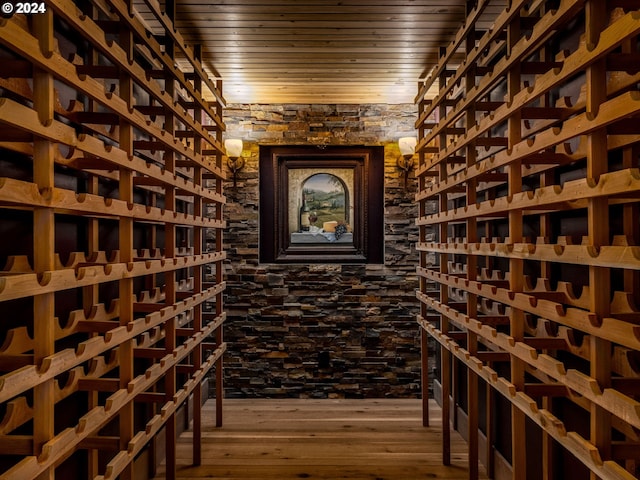 wine area featuring wood-type flooring and wood ceiling