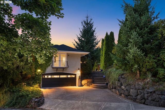 view of front of property featuring a balcony and a garage