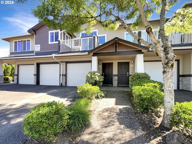 craftsman-style house with a garage and a balcony