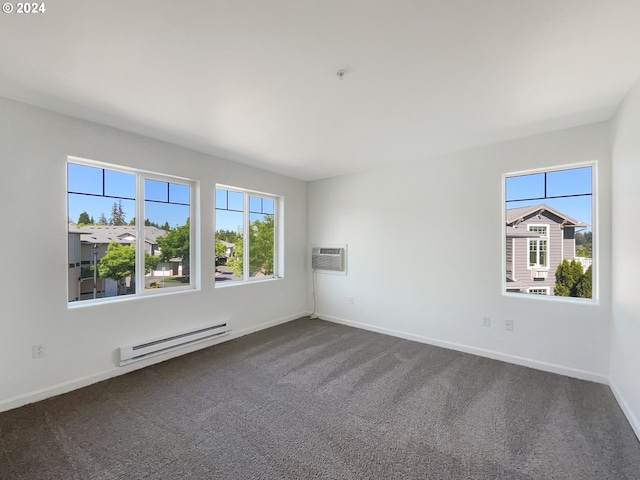 unfurnished room featuring a wall mounted AC, baseboard heating, and dark colored carpet