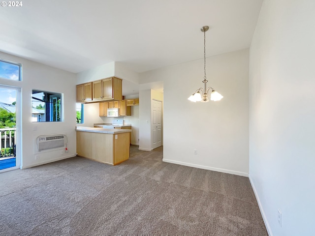 kitchen with plenty of natural light, white appliances, carpet, and kitchen peninsula