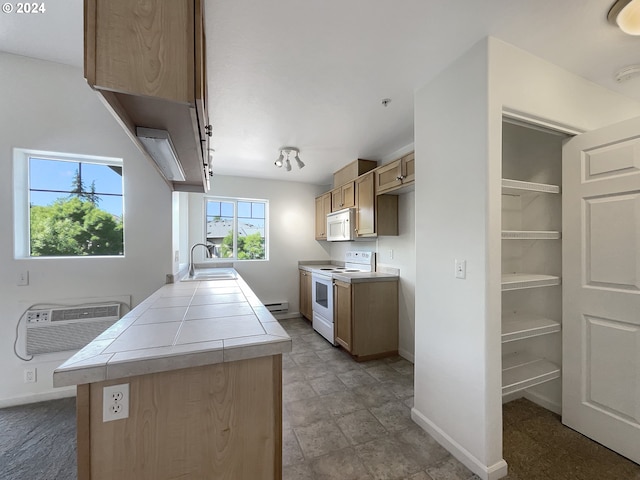 kitchen featuring tile flooring, white appliances, tile counters, baseboard heating, and sink