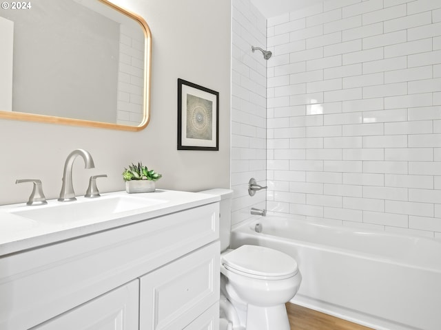 full bathroom with vanity, toilet, tiled shower / bath combo, and wood-type flooring