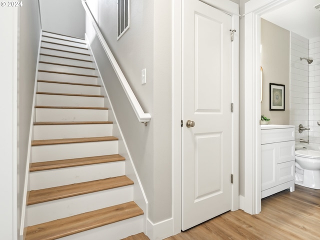 staircase featuring wood-type flooring