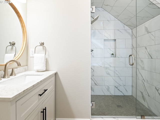 bathroom with a shower with door and vanity