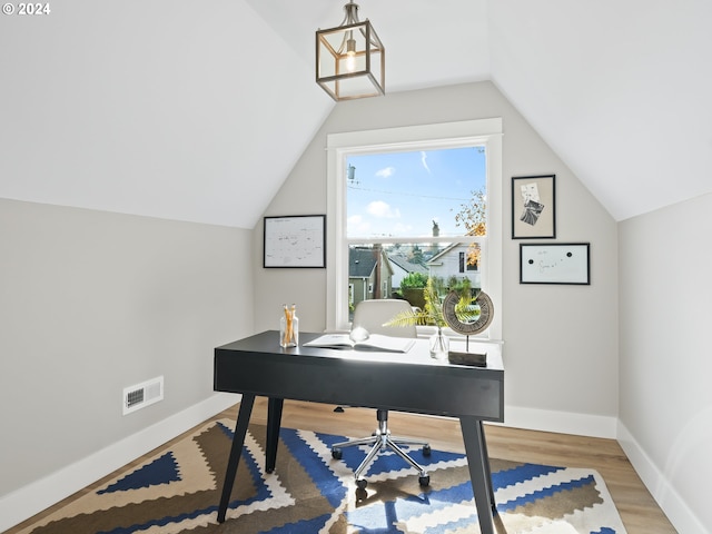 home office featuring wood-type flooring and lofted ceiling