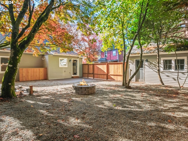 view of yard featuring a patio area and a fire pit